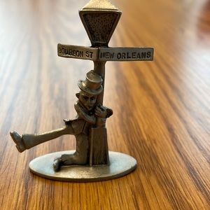 Pewter drunk man, holding onto the light post at Bourbon Street in New Orleans.